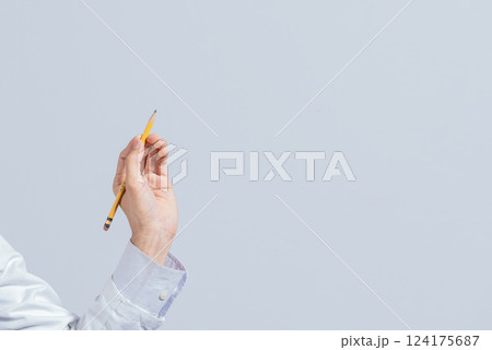 Hand with a pencil pointing at a blank space. Male hand holding a pencil on a blank. Man fingers holding a pencil with blank space. Person's hands holding a pencil on a space for text Hand with a pencil pointing at a blank space. Male hand holding a pencil on a blank. Man fingers holding a pencil with blank space. Person's hands holding a pencil on a space for text 124175687