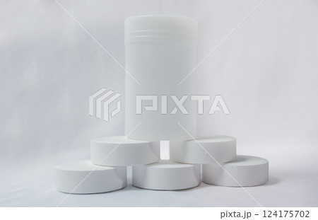 Chlorine tablets for pool cleaning on isolated background. Chlorine tablets for swimming pool disinfection on white background, swimming pool cleaning and maintenance chlorine tablets 124175702