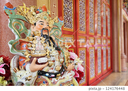 Close up Cai Shen, God Of Wealth Statue in front of Chinese Shrine. Close up Cai Shen, God Of Wealth Statue in front of Chinese Shrine. 124176448