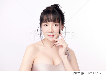 A beautiful young Asian woman with clean, fresh skin against a white background. Skincare, facial treatment, cosmetology, beauty, and spa. An elegant portrait of an Asian woman. A beautiful young Asian woman with clean, fresh skin against a white background. Skincare, facial treatment, cosmetology, beauty, and spa. An elegant portrait of an Asian woman. 124177128