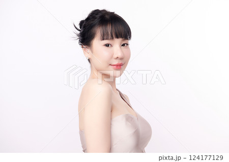 A beautiful young Asian woman with clean, fresh skin against a white background. Skincare, facial treatment, cosmetology, beauty, and spa. An elegant portrait of an Asian woman. A beautiful young Asian woman with clean, fresh skin against a white background. Skincare, facial treatment, cosmetology, beauty, and spa. An elegant portrait of an Asian woman. 124177129