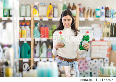 Female buyer choosing dishwashing detergents 124177207