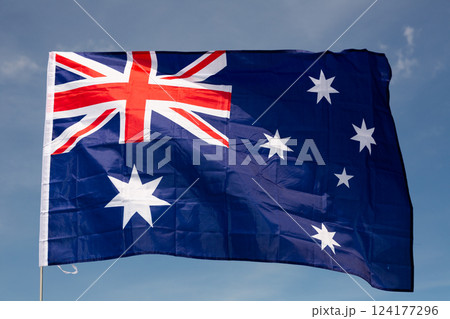 Large flag of Australia waving against sky 124177296