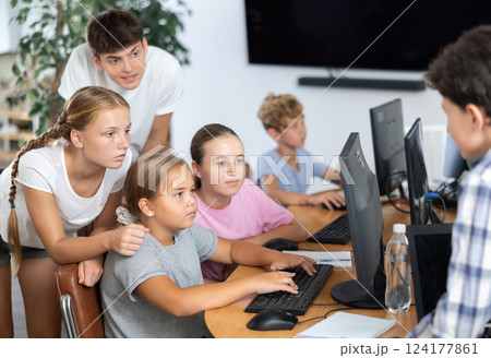 Group of students working at computer in classroom 124177861