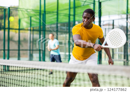 African american man playing padel tennis 124177862