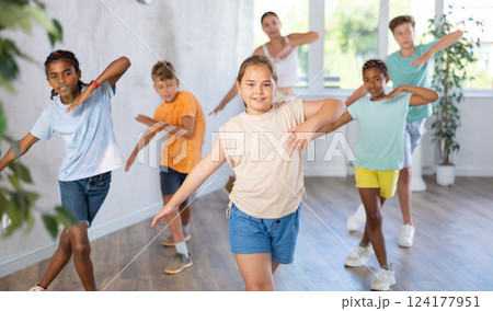 Energetic tween girl practicing vigorous movements in children dance class Energetic tween girl practicing vigorous movements in children dance class 124177951