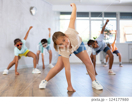 Happy boys and girls enjoying active dance in modern studio Happy boys and girls enjoying active dance in modern studio 124177980