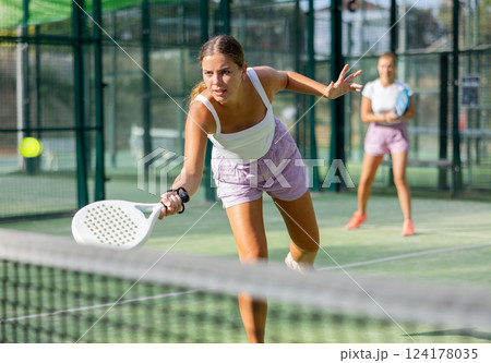Woman padel tennis player training on court 124178035