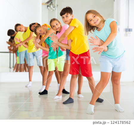 Boys and girls standing in row in dance room 124178562
