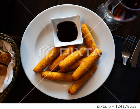 Delicious cheese sticks with mozzarella cheese and sauce Delicious cheese sticks with mozzarella cheese and sauce 124178618