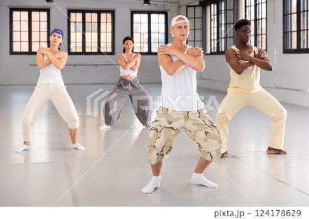 Team of dancers performing hip-hop dance Team of dancers performing hip-hop dance 124178629