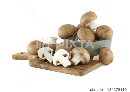 Rustic wooden board displays fresh cremini mushrooms alongside bowl overflowing with earthy delights Rustic wooden board displays fresh cremini mushrooms alongside bowl overflowing with earthy delights 124179119