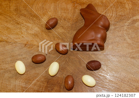 Easter chocolate bunny and chocolate eggs on wooden background. Top view Easter chocolate bunny and chocolate eggs on wooden background. Top view 124182307