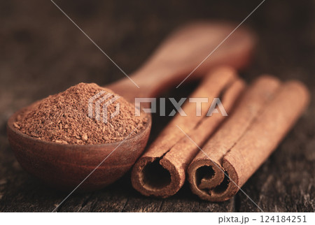 Fresh aromatic cinnamon with ground spice Fresh aromatic cinnamon with ground spice 124184251