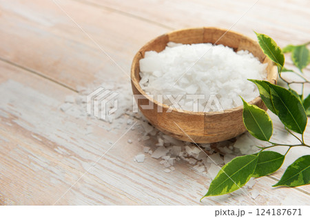 Magnesium flakes in wooden bowl for wellness and relaxation 124187671