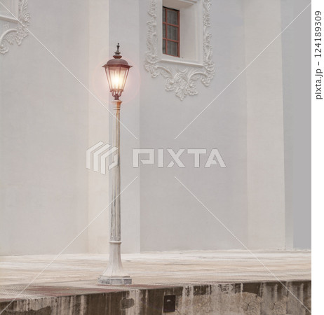 A lantern pole in a square with copy space, An illuminated lantern pole, Public lantern pole, Public lighting pole 124189309