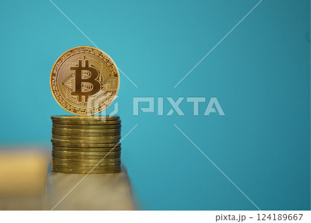 Bitcoin coins with blue background, one gold bitcoin on blue background 124189667