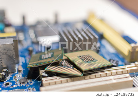 Close up of a motherboard, details of a computer motherboard, detail of a motherboard socket, three processors on a computer motherboard 124189732