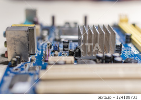 Close up of a motherboard, details of a computer motherboard, detail of a motherboard socket, three processors on a computer motherboard 124189733