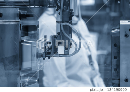 Close up scene material handling process the food container by robotic system from injection machine. 124190990