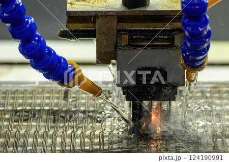 The EDM machine working with graphite electrode. The EDM machine working with graphite electrode. 124190991