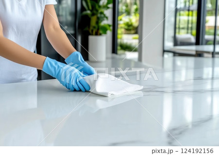 Woman Cleaning Kitchen Countertop Wearing Blue Gloves Woman Cleaning Kitchen Countertop Wearing Blue Gloves 124192156