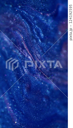 Spilling ink. Shiny stains. Blur blue purple colorful marble enamel texture paint fluid in water spreading on abstract bokeh background. 124192595