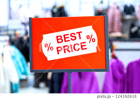 Super price sign on blurred background at a clothes store Super price sign on blurred background at a clothes store 124192618