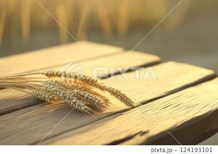 Wheat Ears Resting on Wooden Table Close-Up 124193101