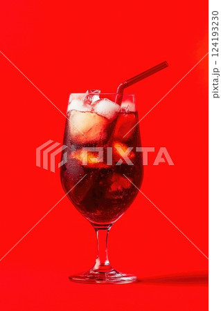 Refreshing iced cola lemonade with red straw 124193230