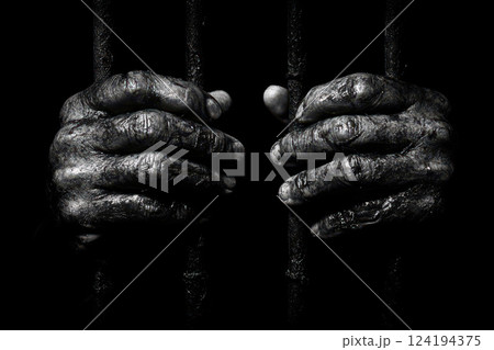 Hands of prisoner man on bars close up isolated on black background. 124194375