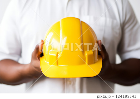 close up Man holding yellow helmet in white background. ai generative 124195543