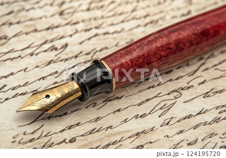 Close-up of an elegant fountain pen resting on vintage handwritten letters.. 124195720