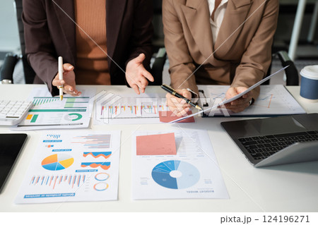 Businessmen team or financial data analysts working with tablets and laptop computers and data graphs together. Plan to analyzing projects in the office. 124196271