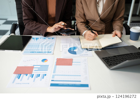 Businessmen team or financial data analysts working with tablets and laptop computers and data graphs together. Plan to analyzing projects in the office. 124196272