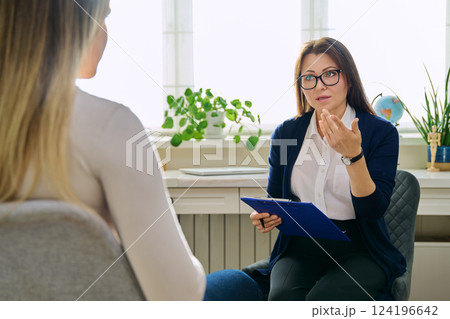 Female psychotherapist, psychologist working with young woman Female psychotherapist, psychologist working with young woman 124196642
