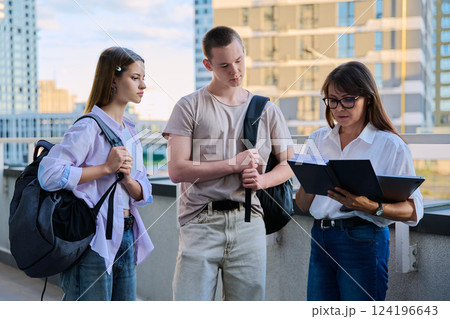 Group of college students talking with female teacher Group of college students talking with female teacher 124196643
