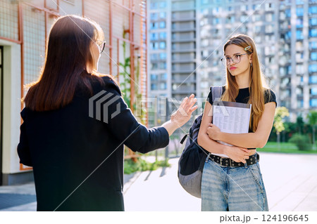 Teenage girl student talking to female teacher, outdoor 124196645
