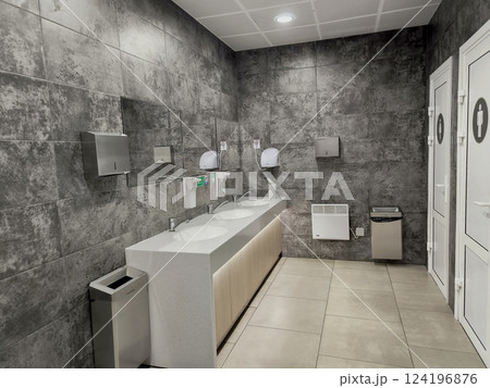 Public toilet with hand washing facilities in white and black 124196876