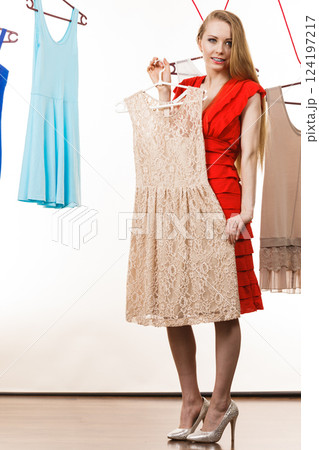 Woman in shop or wardrobe picking dress Woman in shop or wardrobe picking dress 124197217
