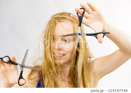 Girl with scissors for haircutting Girl with scissors for haircutting 124197246