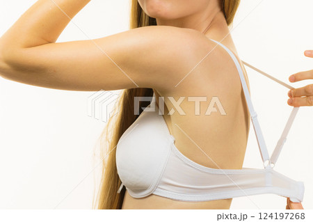 Woman wearing too big bra 124197268