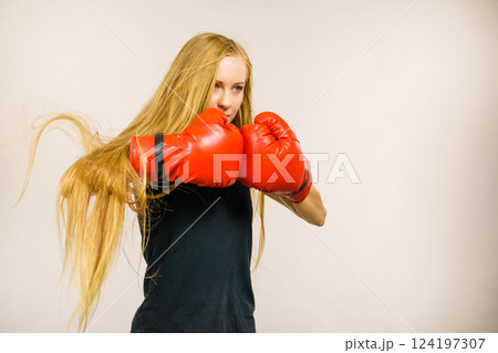 Woman in gloves playing sports boxing Woman in gloves playing sports boxing 124197307