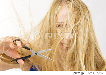 Woman with scissors ready to hair cutting Woman with scissors ready to hair cutting 124197787