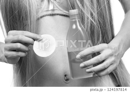 Woman using cleanser cosmetic Woman using cleanser cosmetic 124197814