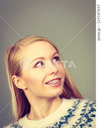 Happy woman showing her braces on teeth 124197837