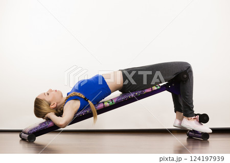 Woman training on bench for sit ups Woman training on bench for sit ups 124197939