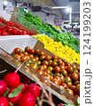Various type of fresh fruits arrange neatly, grocery store. Radishes, tomatoes, yellow peppers, green vegetables on rack.  124199203