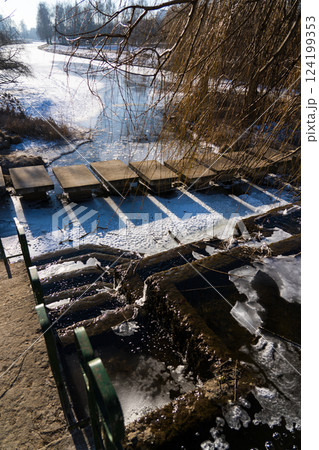 Frozen, old, Soviet waterfall, on a February morning. Looking down Frozen, old, Soviet waterfall, on a February morning. Looking down 124199353