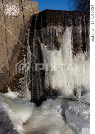 Frozen waterfall water. A frozen waterfall on a February morning 124199354